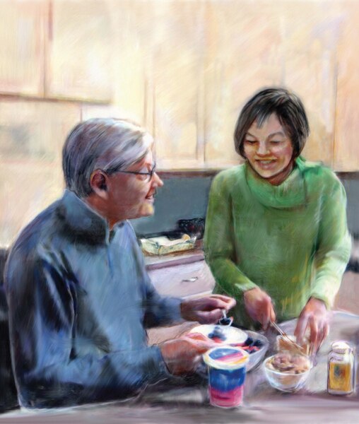 Drawing of a middle-aged man and woman in a kitchen. The man is eating cereal, and the woman is slicing cheese. Also on the kitchen table are a bowl of almonds, a container of yogurt, and a bottle of lactase enzyme tablets.