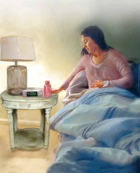 A woman sitting in bed with her hand on her abdomen in discomfort. She’s reaching for a bottle of liquid medicine on her nightstand.