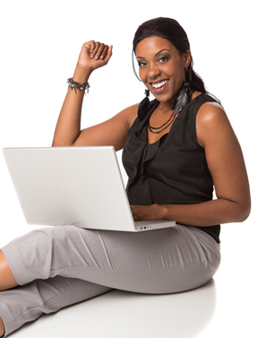 Woman holding a laptop and sitting on the floor with outstretched legs
