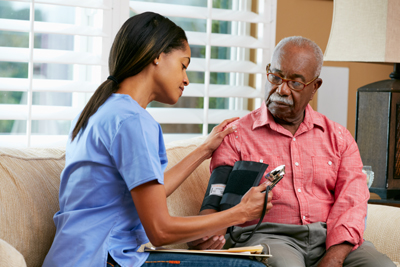 Man having his blood pressure checked by a health care professional.