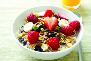Photo of a bowl of cereal with fresh strawberries