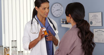 A health care professional talking to a patient about medicine.