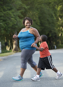 Woman walking with a young boy.