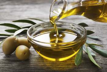 Olives and container of oil.